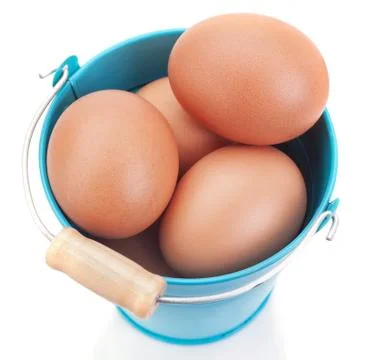 Chicken Easter eggs in a blue bucket. On a white background. 스톡 사진