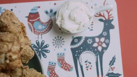 Chicken edge crossing a patterned christmas placemat Stock Photos