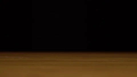 A chicken egg breaks from falling onto a table. The egg falls to the surface and Stock Footage 123359396