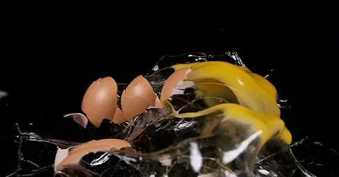 Chicken Egg Exploding against Black background, Slow motion 4K Stock Footage 75969469