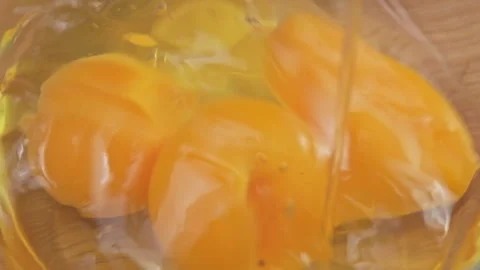 Chicken egg falls in slow motion into a glass bowl close-up. Stock Footage 220176391