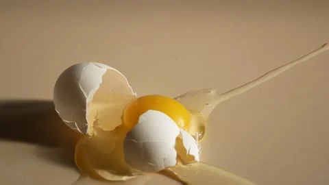A chicken egg falls on the table and breaks Stock-Footage 168231169