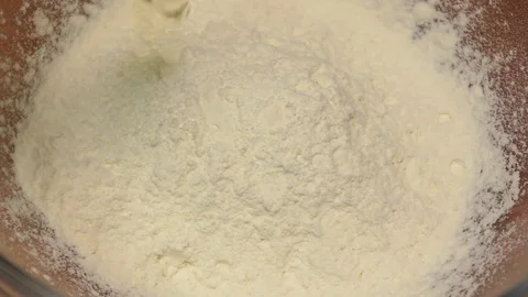 Chicken egg falls into wheat flour in slow motion. Closeup Stock Footage 76168533