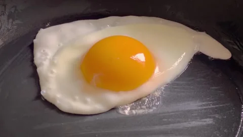 Chicken egg is fried in a pan. Stock Footage 240996643