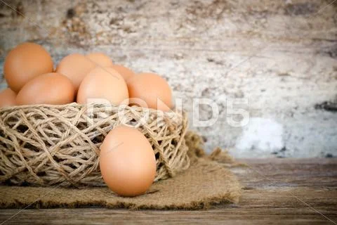 Chicken Egg In Nest On Wood Background