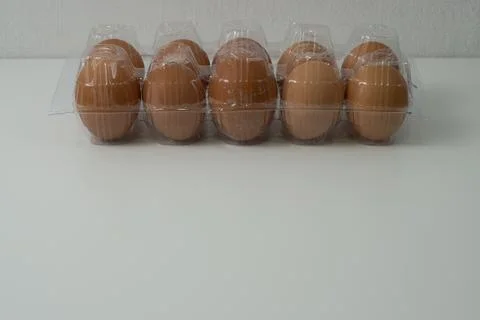 Chicken egg with plastic container on white background 11 Stock Photos