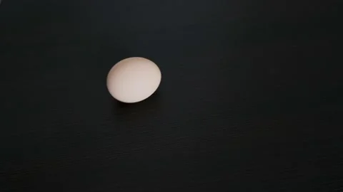 A chicken egg rotates around its axis. Close-up Stock Footage 233274050