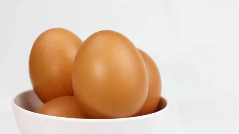 Chicken egg rotates on a white background. Close-up of an egg Stock Footage 147939317