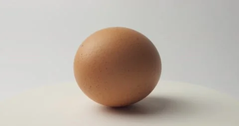 Chicken egg rotates on a white background. Stock Footage 148624943