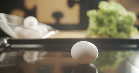 Chicken egg spinning in slow motion on the kitchen table. 4K video Stock Footage 117292190