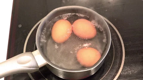 Chicken eggs are cooked in a pan on an electric stove Stock Footage 47209314
