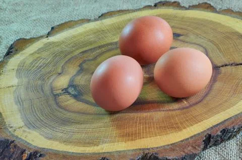 Chicken eggs are cut on a tree, on a linen napkin. Top view, copy space. Food Stock Photos
