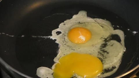 Chicken eggs are fried in a pan Stock Footage 144760513