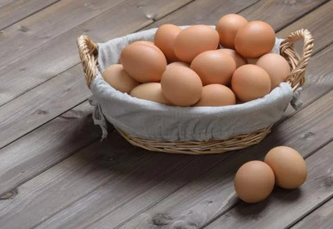Chicken eggs in a basket Stock Photos