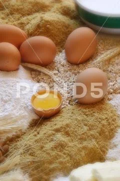 Chicken eggs with a broken egg and some beans and flour recipe Stock Photos