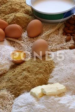 Chicken eggs with a broken egg and some beans and flour recipe Stock Photos