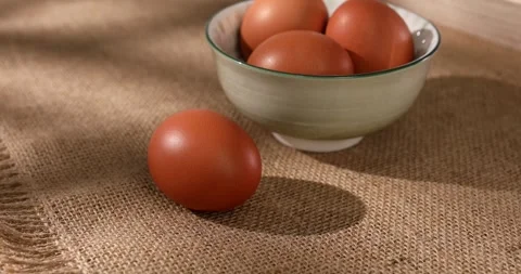 Chicken eggs on burlap. fresh eggs in a bowl. farm product closeup. Stock Footage 242491374