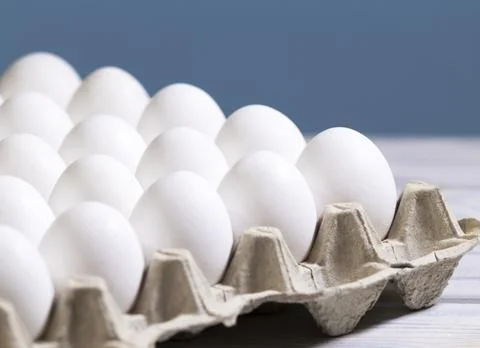 Chicken eggs in a cardboard box on a light blue background, Raw Fresh Chicken Stock Photos