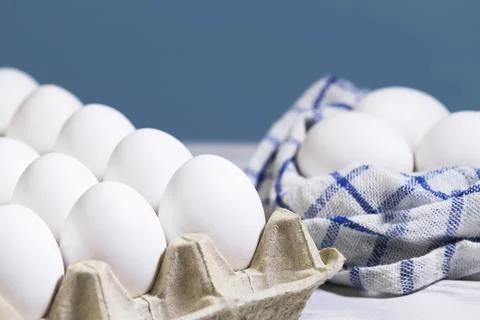 Chicken eggs in a cardboard box on a light blue background, Raw Fresh Chicken Stock Photos