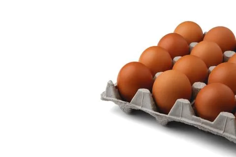 Chicken eggs in the container on the right isolated on a white background. Foto stock