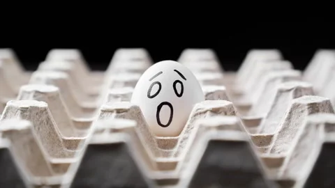 Chicken eggs in egg box carton. Funny faces on brown and white eggs. Stock Footage 302970528