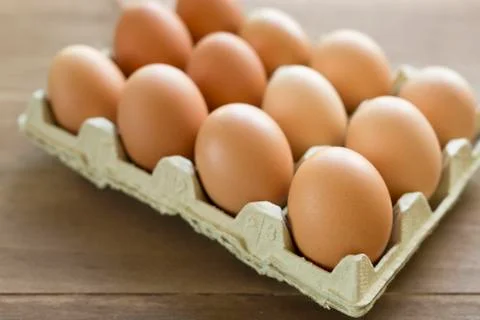 Chicken eggs in an egg cup Stock Photos