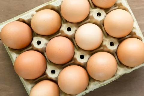 Chicken eggs in an egg cup Stock Photos
