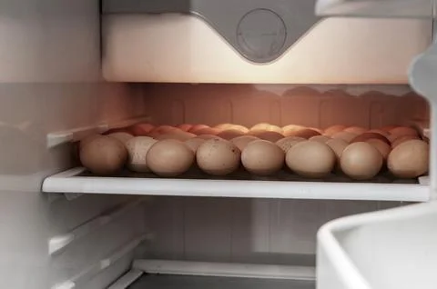 Chicken eggs in the fridge. Preparation for Easter. Stock Photos