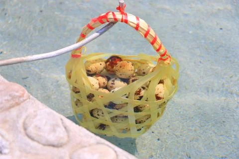 Chicken eggs in large and small baskets. It is soaked in mineral water to t.. Stock Photos