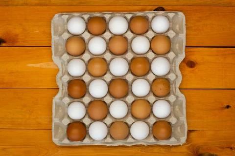 Chicken eggs in a package on the table. Brown and white chicken eggs Stock Photos