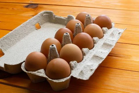Chicken eggs in a package on the table. Brown chicken eggs in a recycled Stock Photos