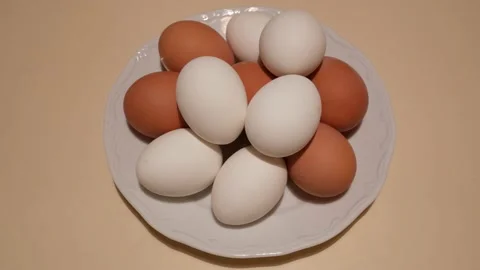 Chicken eggs in a plate on the table Stock Footage 219426657