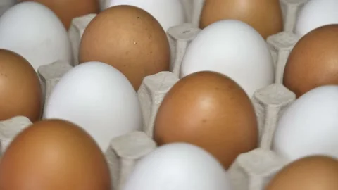Chicken eggs rotates, top view. Raw eggs in the tray .Easter eggs background Stock Footage 178833299