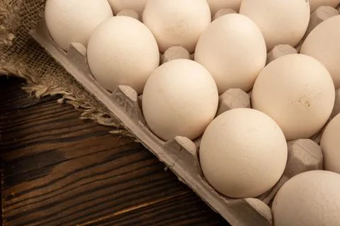Chicken eggs, vWhite chicken eggs in a cardboard box on the table. Close-up,  Stock Photos