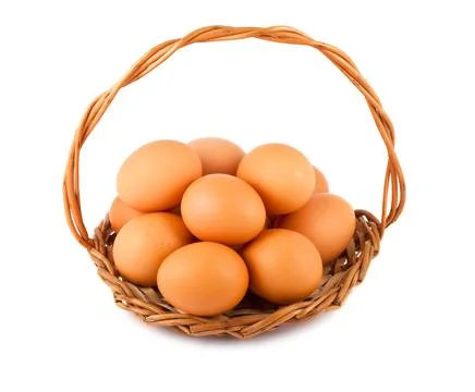 Chicken eggs on wicker basket Stock Photos