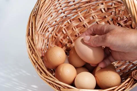 Chicken eggs from a wicker basket Foto stock