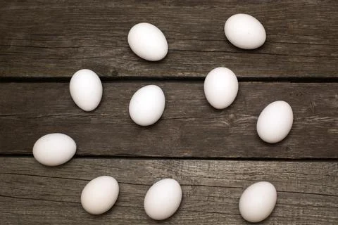 Chicken eggs on wooden rustic table. Top view. Stock Photos