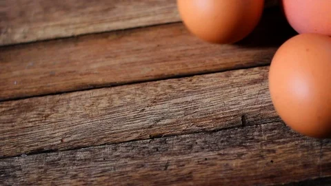 Chicken eggs on wooden table Stock Footage 104689287