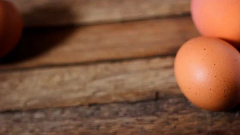 Chicken eggs on wooden table Stock Footage 104689301