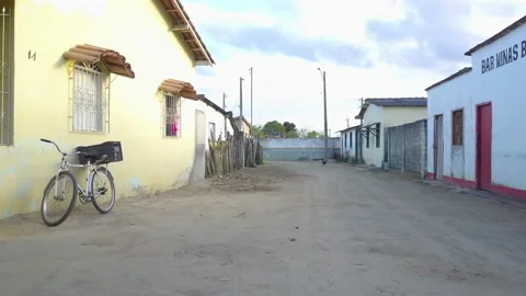 Chicken on empty street of Nova Visçosa, low flying drone point of view Stock Footage 146953104