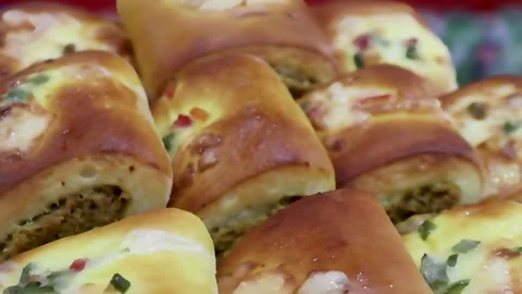 Chicken filled snack rolls arranged in warm bakery setting captured Stock Footage 338164472
