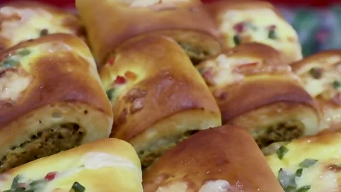 Chicken filled snack rolls arranged in warm bakery setting captured Stock Footage 338164502