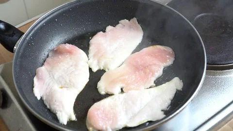Chicken fillet being fried in the pan Stock Footage 79743829