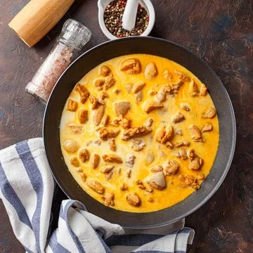 Chicken fillet cut into small pieces for frying in pan Stock Photos