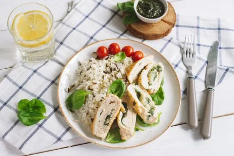 Chicken fillet roll with spinach, on a bed of long grain wild rice Stock Photos