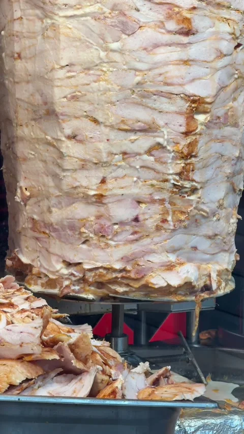 Chicken fillet on a spit. Making shawarma. Video stock 336915344
