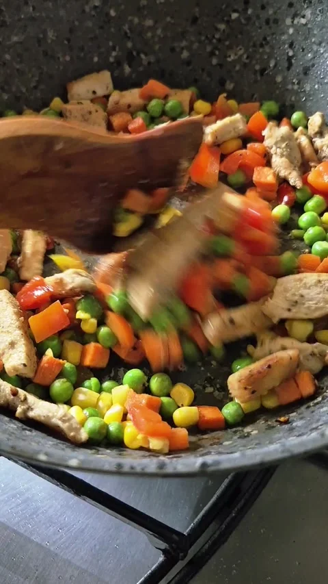 Chicken fillet with vegetables fried in a frying pan Stock Footage 325856653