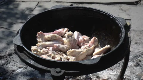 Chicken is fried in a cauldron, over an open fire Stock Footage 110769771