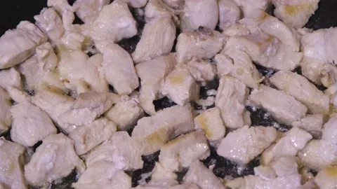 The chicken is fried in a pan. Meat in a pan. Dietary meat in a pan. Stock Footage 232420600