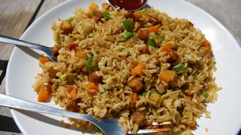 Chicken fried rice with vegetables like carrot, onion, etc and tomato sauce Stock Footage 246676151